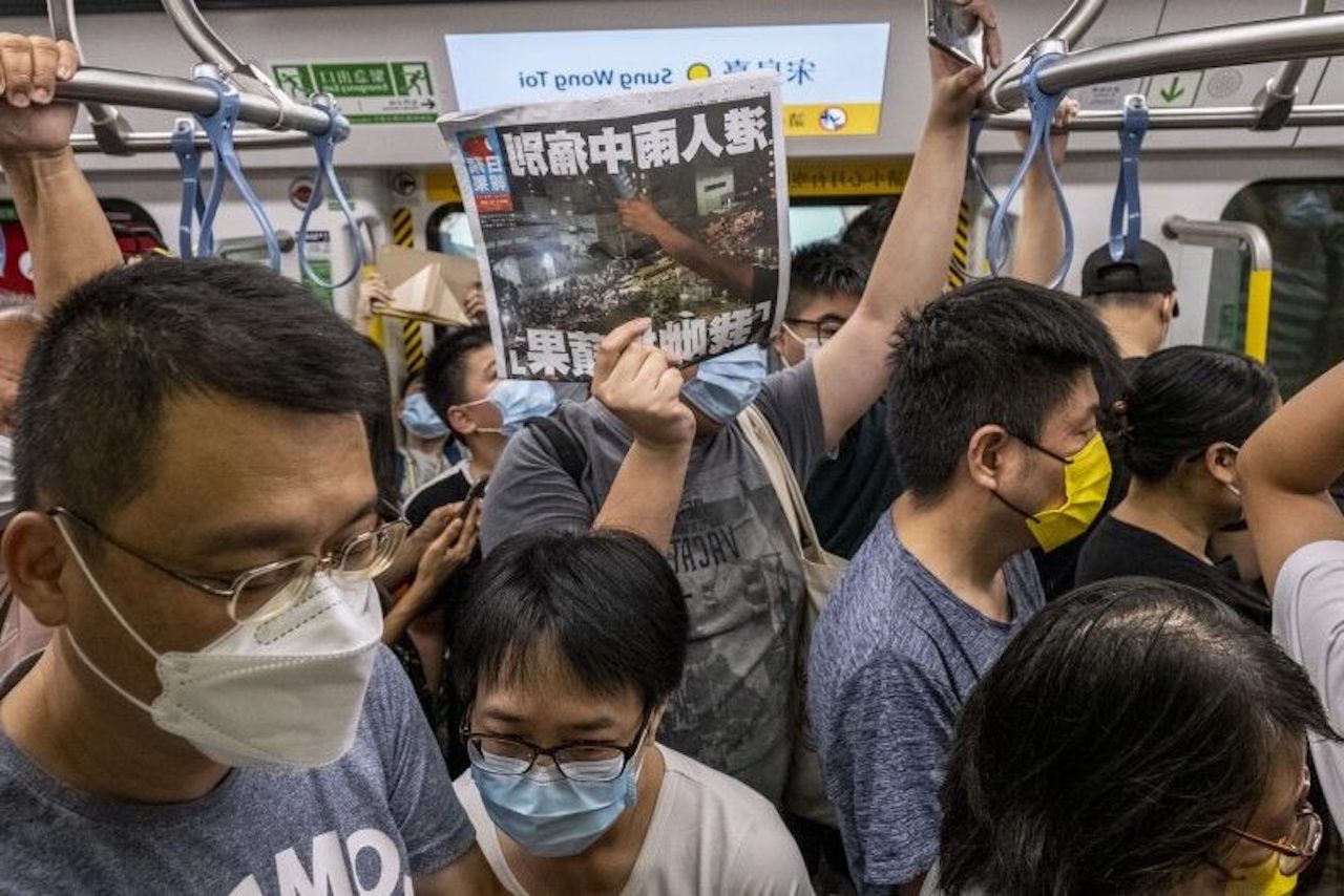A man holds a pro-democracy newspaper Apple Daily in Hong Kong.