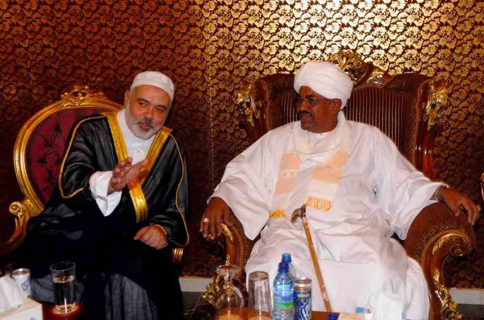Former Sudan dictator Omar al-Bashir (R) meeting with Hamas leader Ismail Haniyeh at the Nur mosque in Khartoum on 30 December 2011.