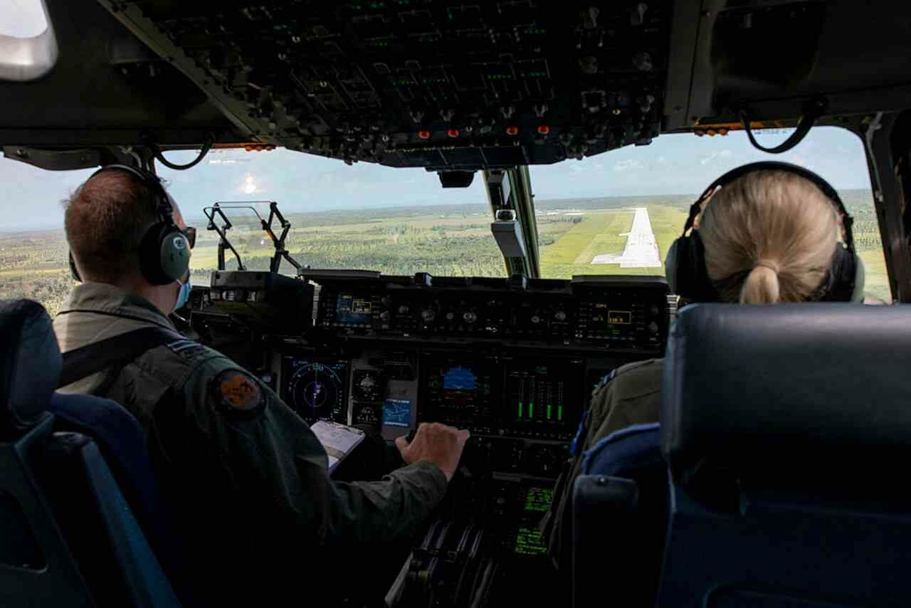 Australian RAAF Pilots in the cockpit of a C-17A Globemaster III, as they prepare to land at Fua’amotu International Airport, Tonga.