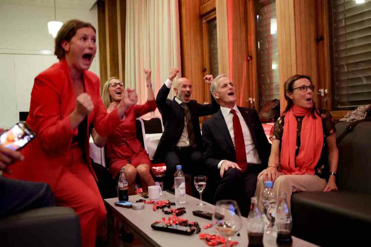Norway's Labor leader Jonas Gahr Store (2nd R) cheers after seeing the exit poll results at an election event in Oslo.